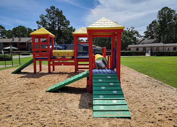 a playground with a slide and a basketball on it